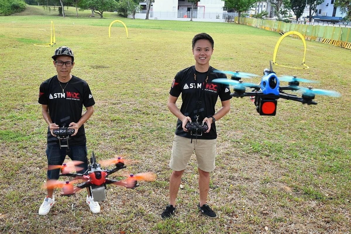 Dance-studio owner Felix Huang (far left) and software developer Ryan Tan with their drones.