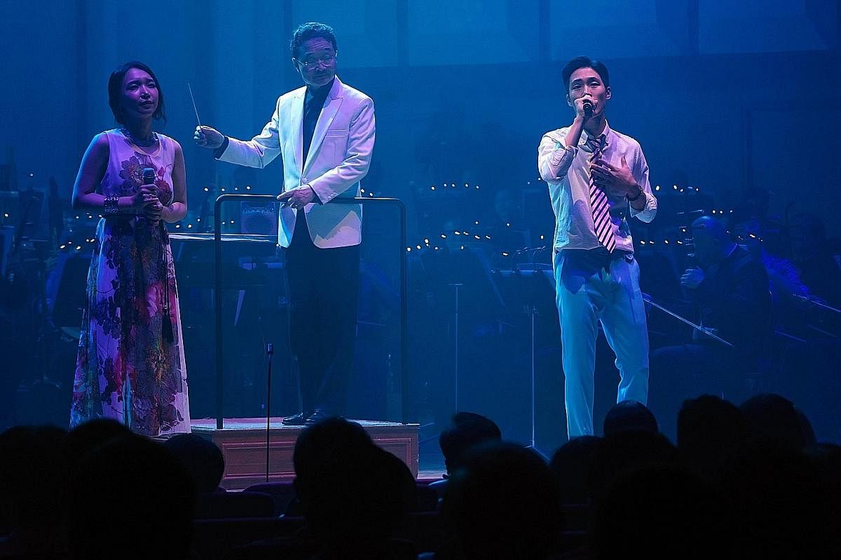 South Korean singers Chai Khan (left) and Kim Hyun-su (right) performing with the Singapore Chinese Orchestra during the Korea, New Waves concert in September 2016. In the centre is SCO music director Yeh Tsung.