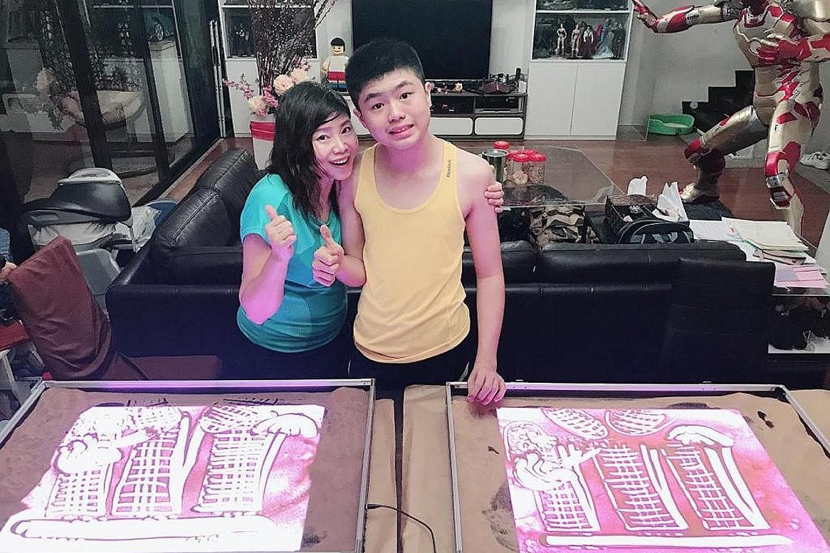Mrs Florence Choy (next to her son Julian) says he has moderate autism and misses going to school, working out at the gym and having play dates with his friends - and sometimes has a meltdown. Ms Magdalene Ong has kept her son Chalmers Wong occupied 