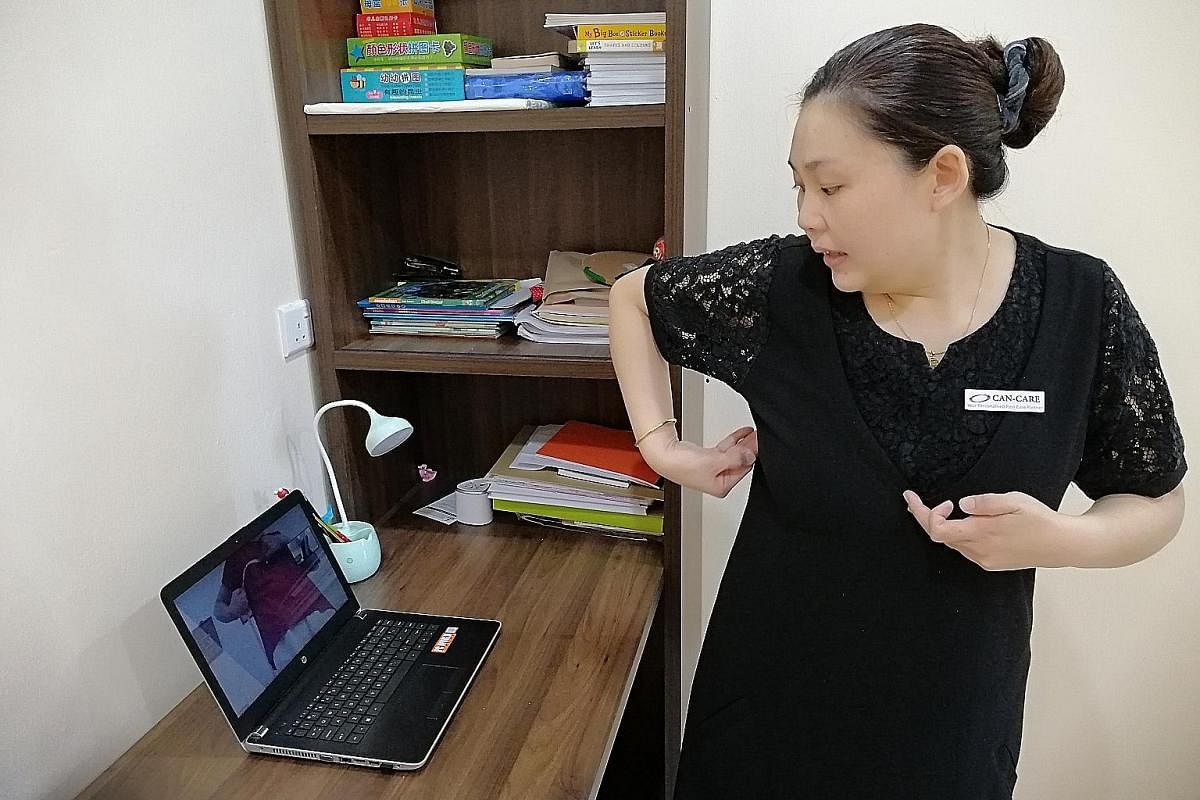 Can-Care patient care executive Wong Seow Chyi guides a patient through a free online personalised mastectomy bra-fitting session.