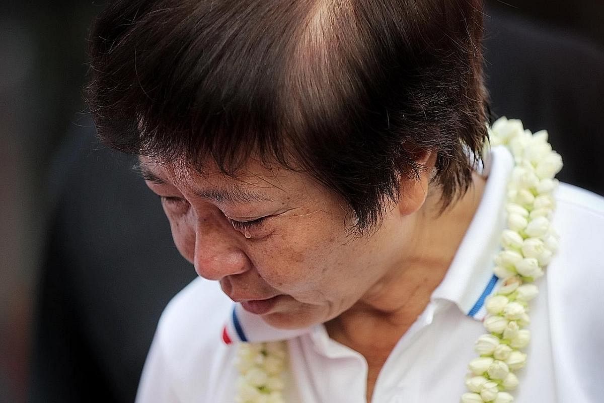 BEST FEET FORWARD: Mr Tan Chuan-Jin, 51, PAP candidate in the Marine Parade GRC team, seen in shoes with the words "maju" and "lah" during a doorstop interview in Serangoon Avenue 3 last Thursday. ST PHOTO: KEVIN LIM TEARFUL FAREWELL: Outgoing PAP MP