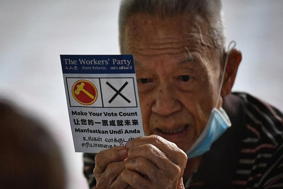 BEST FEET FORWARD: Mr Tan Chuan-Jin, 51, PAP candidate in the Marine Parade GRC team, seen in shoes with the words "maju" and "lah" during a doorstop interview in Serangoon Avenue 3 last Thursday. ST PHOTO: KEVIN LIM TEARFUL FAREWELL: Outgoing PAP MP