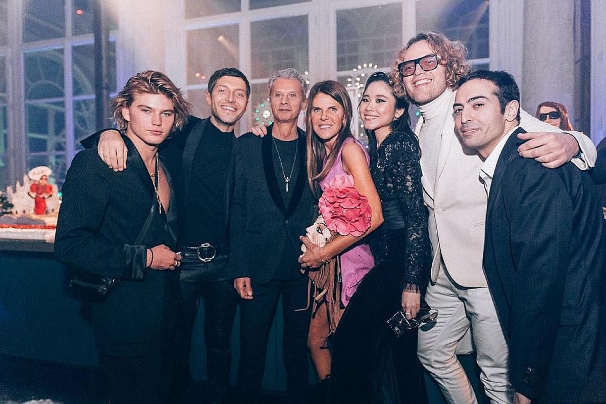 Ms Nga Nguyen (fifth from left) with (from left) model Jordan Barrett, actor Evangelo Bousis, businessman Angelo Gioia, fashion editor Anna Dello Russo, designer Peter Dundas and film-maker Mohammed Al Turki at a party she co-hosted with Dello Russo 