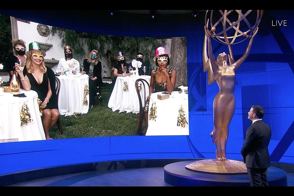This year's Emmy Awards, hosted by Jimmy Kimmel (above right), is the first major Hollywood ceremony to broadcast live amid the pandemic. The show went largely virtual, with stars, such as Reese Witherspoon (on screen, foreground left) and Kerry Wash