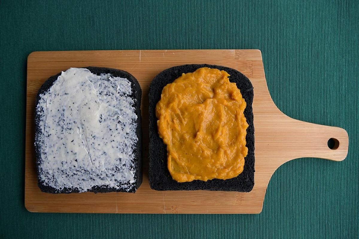 Slices of charcoal bread smeared with cream cheese (far left) and pumpkin spread (left). The dough used to make charcoal bread is versatile and quite easy to work with.