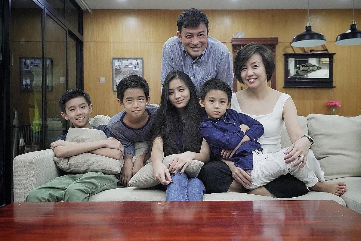 Evelyn Tan and Darren Lim with their children (above, from left), Jairus, 13, Way, 11, Kristen, 15, and Elliott, seven. The family now live in a condominium unit in Upper Changi. Darren Lim's 500 sq ft, three-room Lagoon 400S2 catamaran (left) is amo