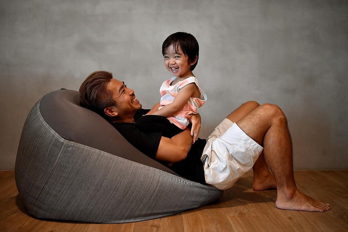 Stay-at-home dad Adrian Sim Wei Lim talking with his two-year-old son Rei Shen Yuxiang.