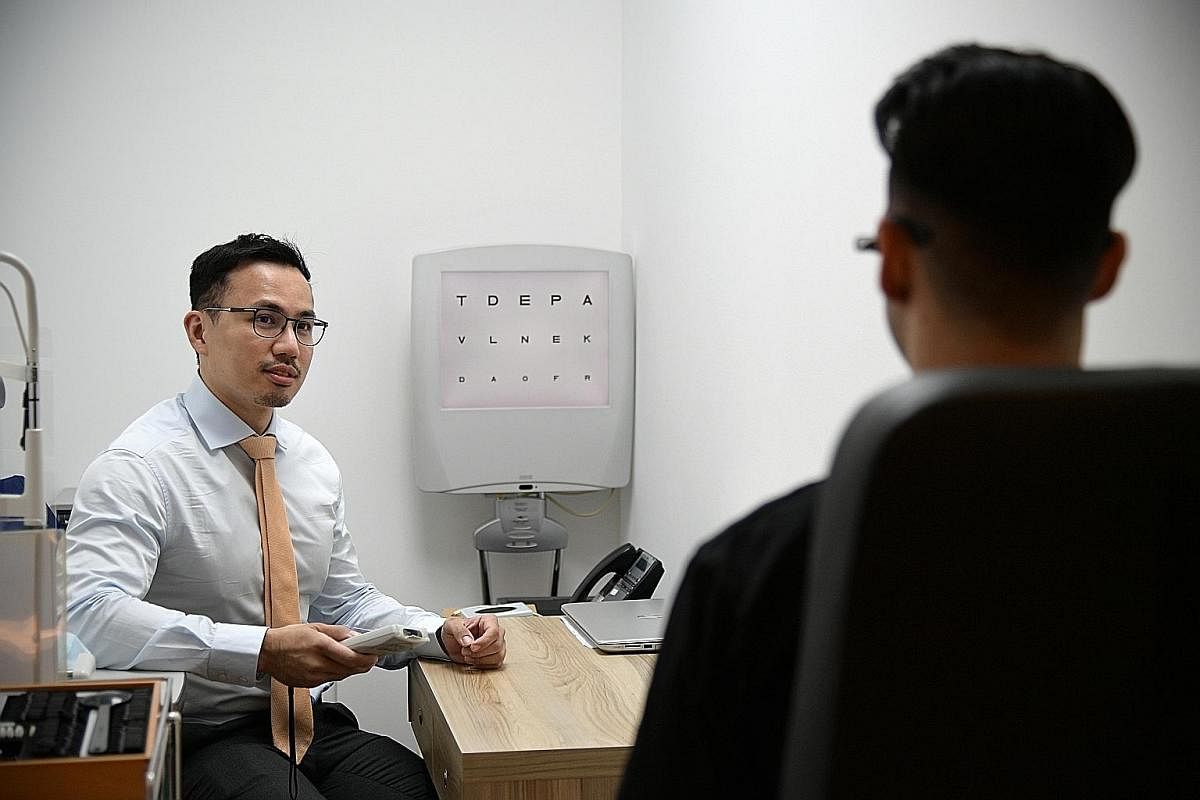Dr Errol Chan, a consultant ophthalmologist at LSC Eye Clinic, testing how well a patient can see with the use of an eye chart.