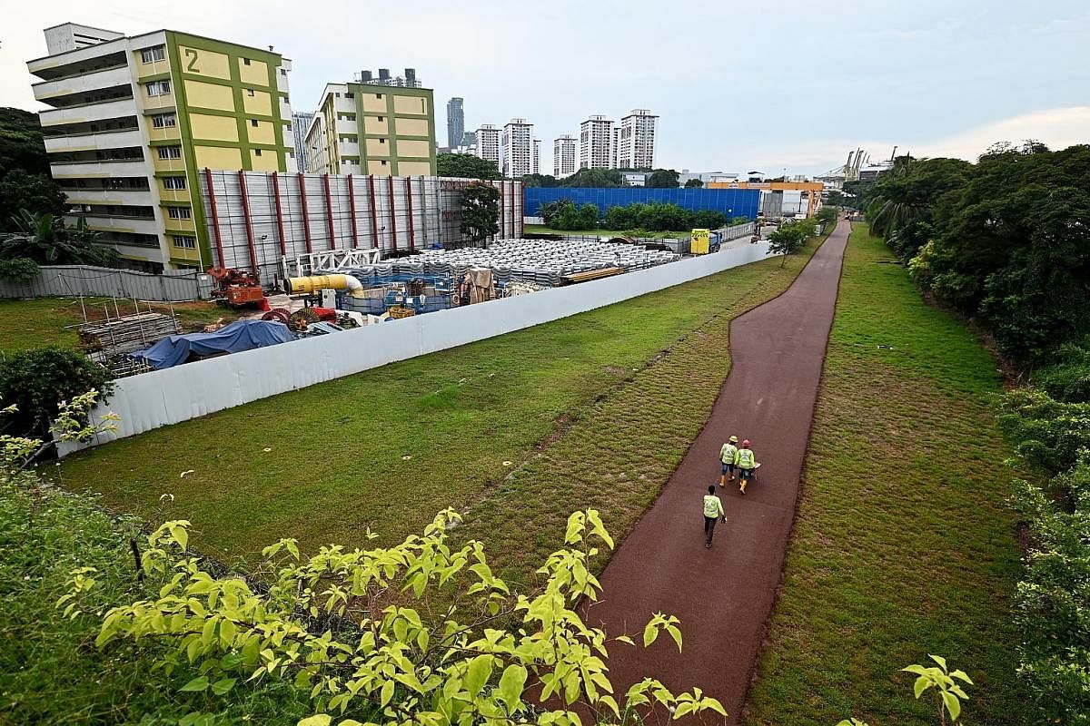 Workers at a section of the Rail Corridor in Spooner Road in November last year. Two blocks of flats there used to house railway staff, but were later converted to rental homes for the lower-income group.