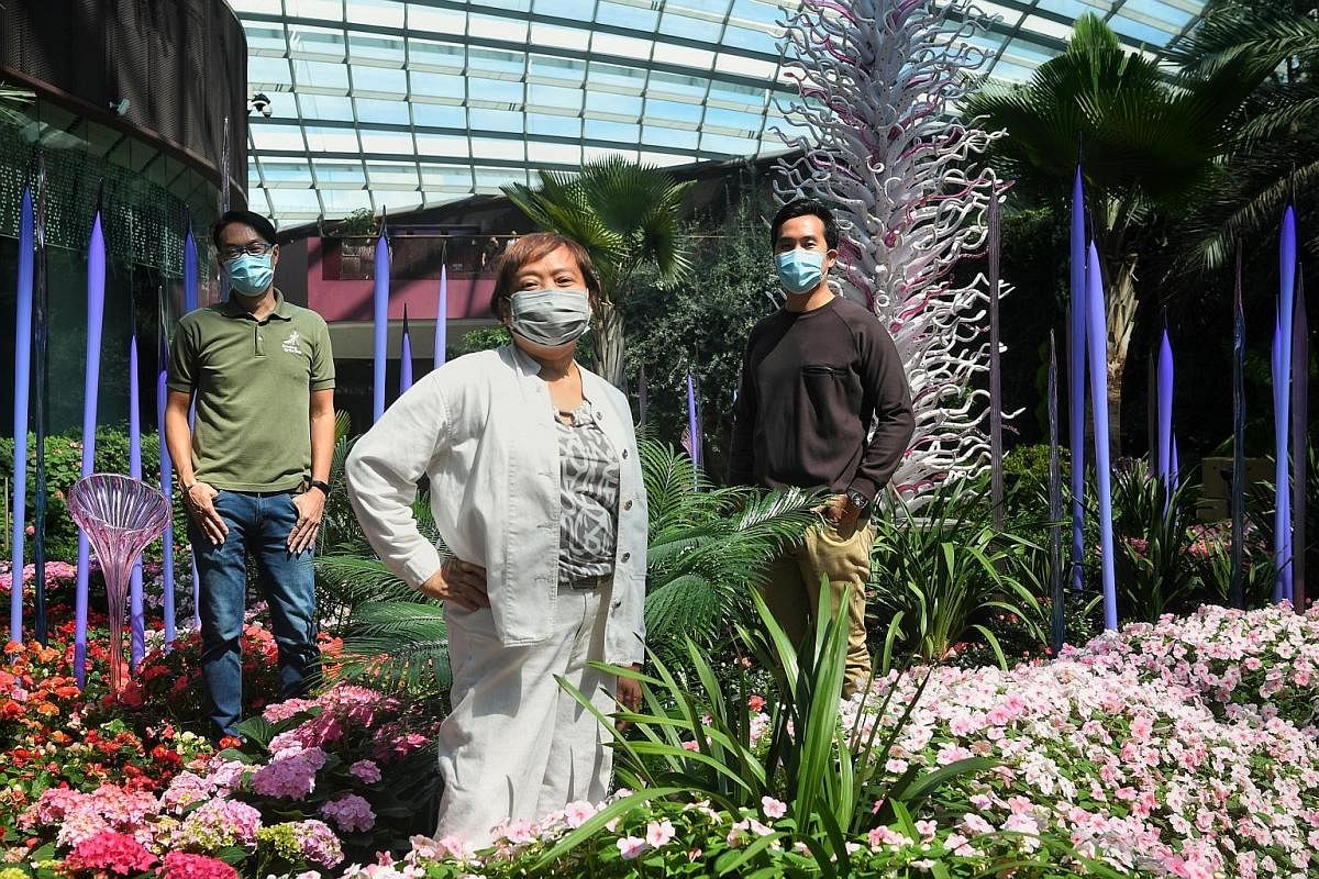 Gardens by the Bay's (from far left) Mr Gary Chua and Ms Marziah Omar, and Mr Michael Lee, the exhibition's organising committee chairman, in the Flower Dome, which incorporates three Chihuly works: The White Tower, Neodymium Reeds, and Erbium Reeds 