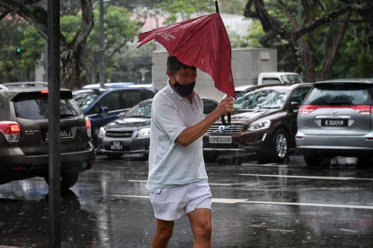 In Pictures: Persistent rain in Singapore sparked by sea breezes ...