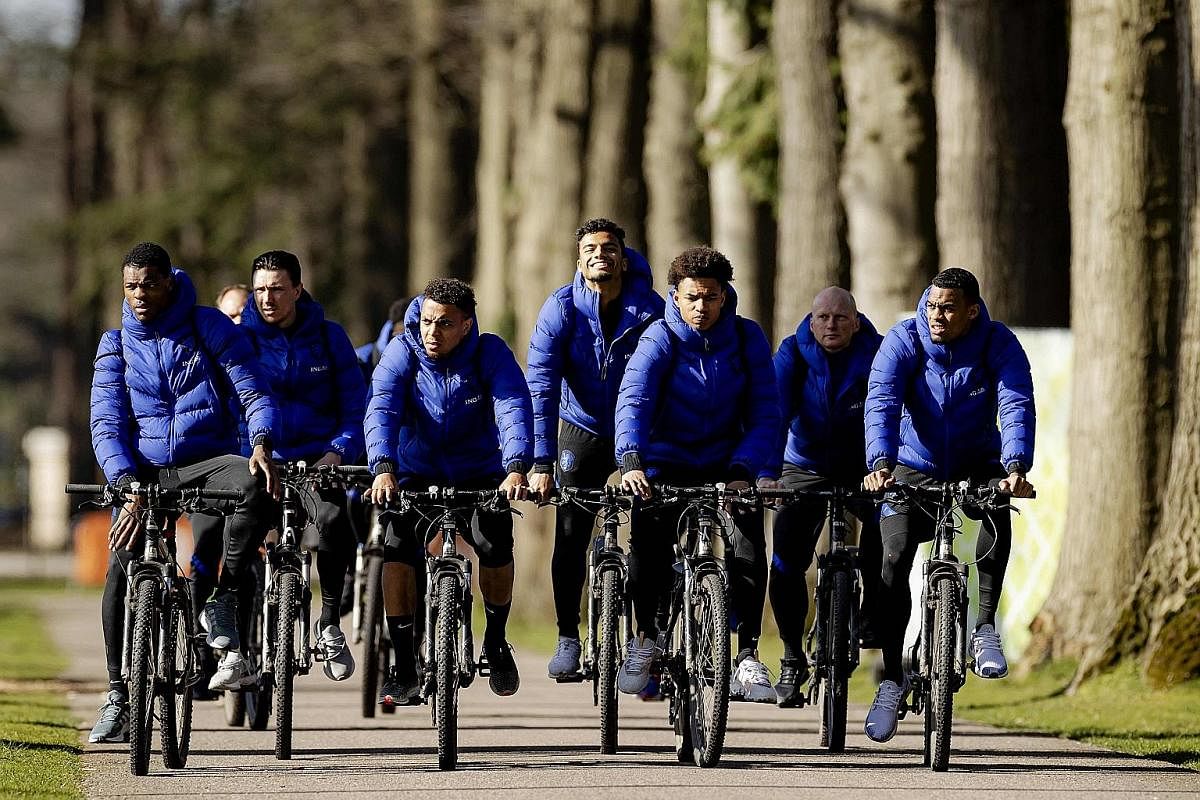 Netherlands players riding bicycles to a training session ahead of a World Cup qualifier in March. Coach Frank de Boer is positive ahead of Euro 2020, saying "we are not far off the favourites".