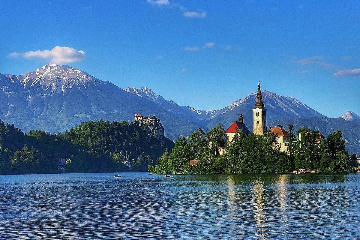 When borders reopen further, enjoy leisurely walks around Slovenia's serene and picturesque Lake Bled (above) and experience life in the desert in Dunhuang in China (left).