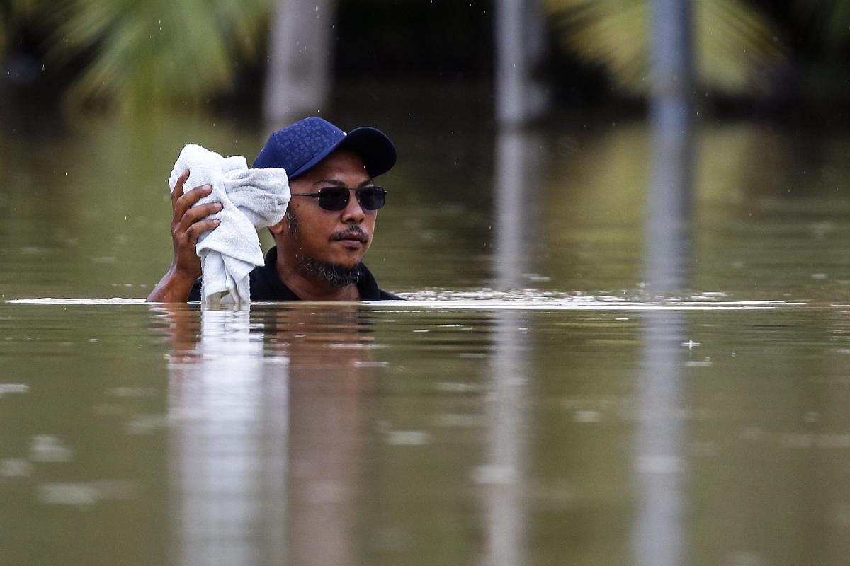 In Pictures: More Than 50,000 People Displaced By Flooding In Malaysia ...